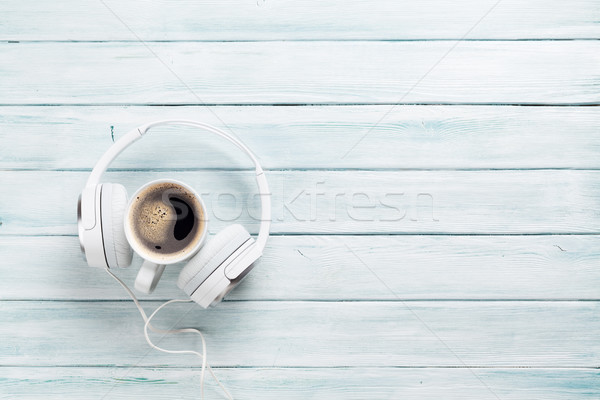 Headphones and coffee cup on wooden table Stock photo © karandaev