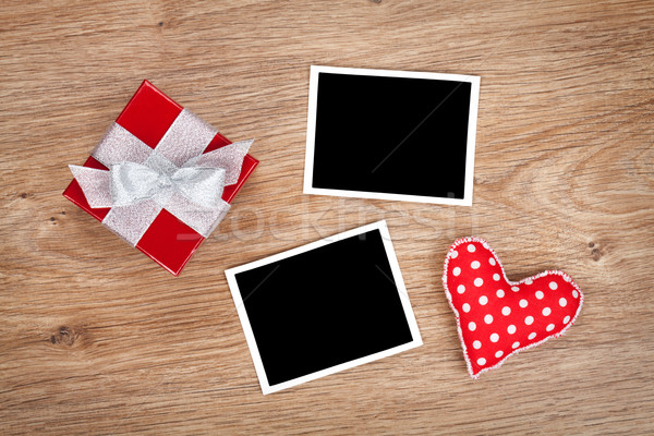 Blank photo frames and small red gift box Stock photo © karandaev