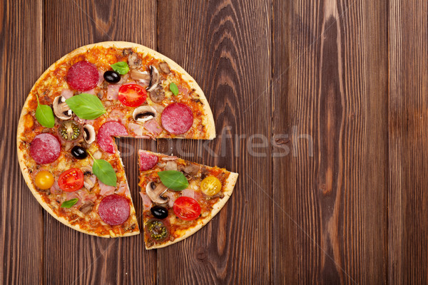 Italian pizza with pepperoni, tomatoes, olives and basil Stock photo © karandaev