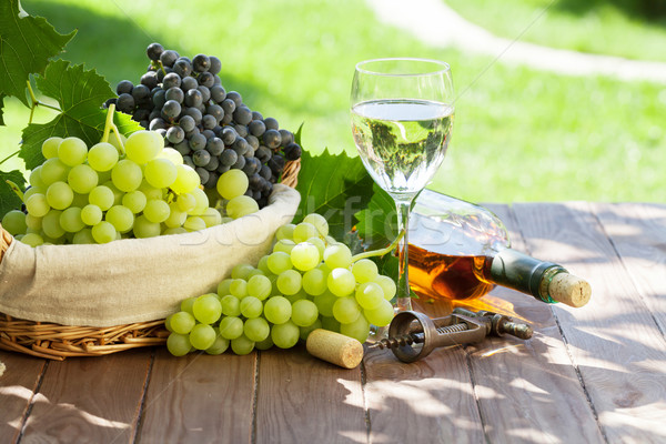Wine and grape on garden table Stock photo © karandaev