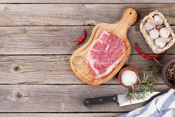 Stock photo: Raw beef steak with spices and herbs