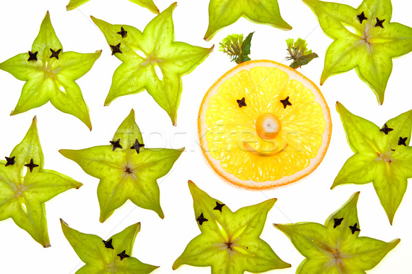 Starfruit (carambola) slices with orange face Stock photo © karandaev