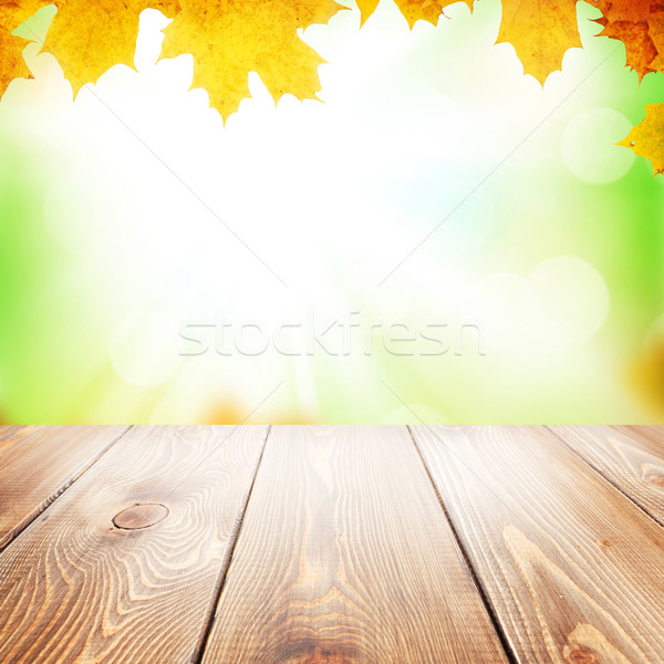 Autumn nature background with maple leaves and wooden table Stock photo © karandaev