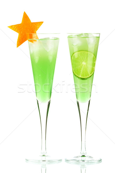 Mint Champagne alcohol cocktail with orange star and lime slice Stock photo © karandaev