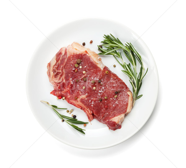Stock photo: Raw sirloin steak with rosemary and spices on plate
