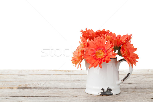 Orange gerbera flowers in pitcher Stock photo © karandaev