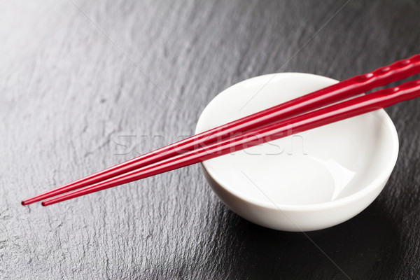 Japanese sushi chopsticks over soy sauce bowl Stock photo © karandaev