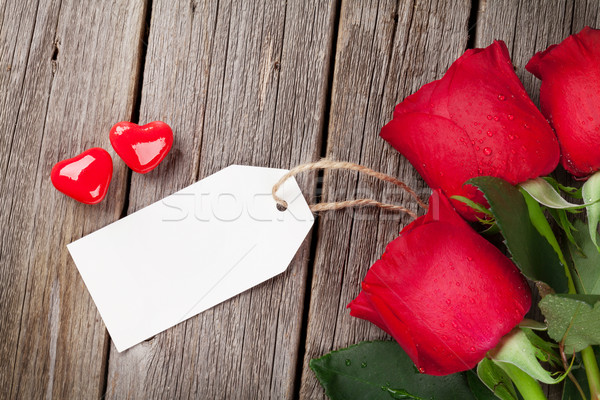 Stock photo: Red rose and candy hearts over wood