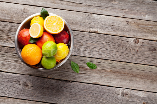 Fresh citrus fruits in colander Stock photo © karandaev