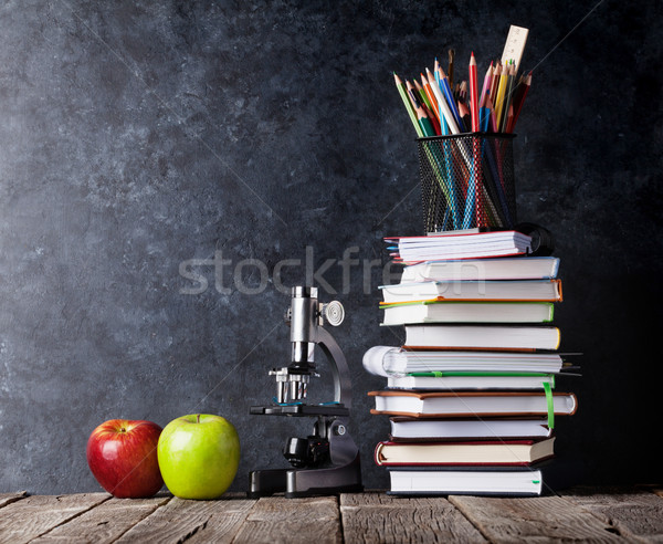 Notepads, supplies and apples in front of chalk board Stock photo © karandaev