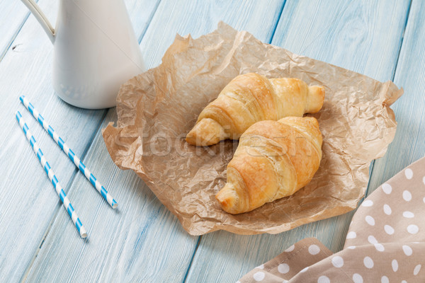 Fresco croissants leite mesa de madeira papel tabela Foto stock © karandaev