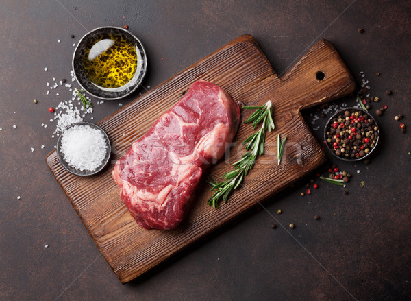 Raw ribeye beef steak cooking with ingredients Stock photo © karandaev