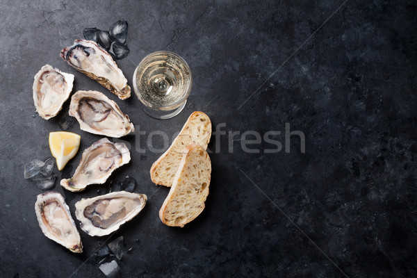 Oysters with lemon and white wine Stock photo © karandaev