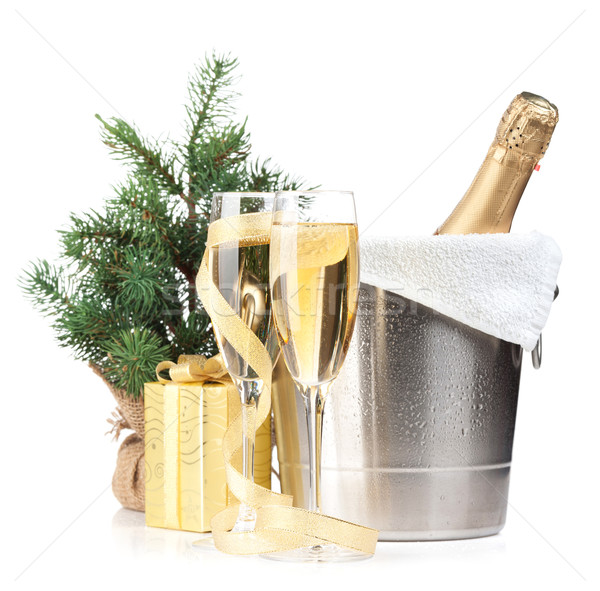 Champagne bottle in ice bucket, two glasses and christmas gift Stock photo © karandaev