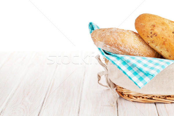 Fraîches pain français panier blanche table en bois nature Photo stock © karandaev