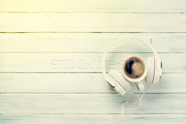 Headphones and coffee cup on wooden table Stock photo © karandaev