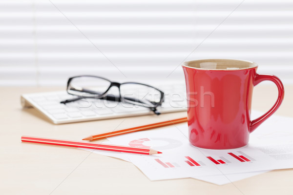 Office workplace with coffee and charts Stock photo © karandaev