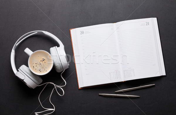 Office desk table with notepad, headphones, coffee Stock photo © karandaev