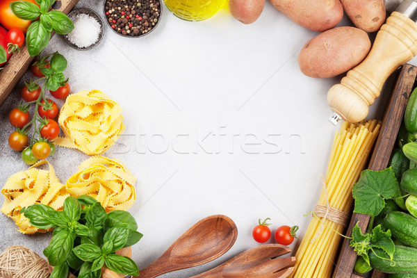 Fresh garden tomatoes, cucumbers and pasta on cooking table Stock photo © karandaev