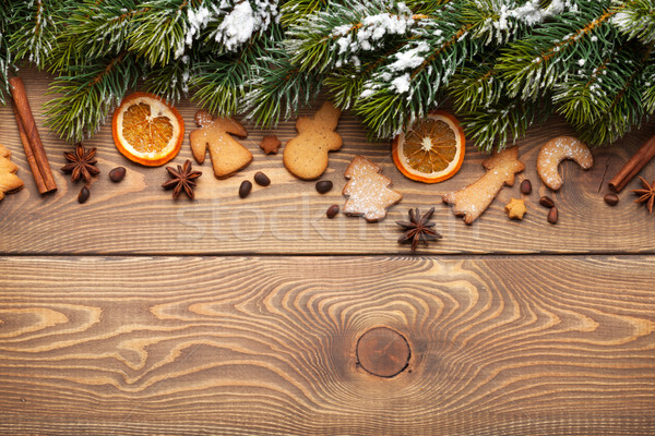 Christmas wooden background with snow fir tree, spices and 