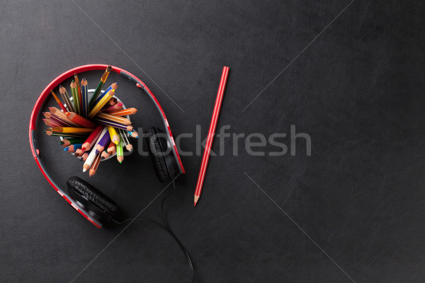Office leather desk with pencils and headphones Stock photo © karandaev