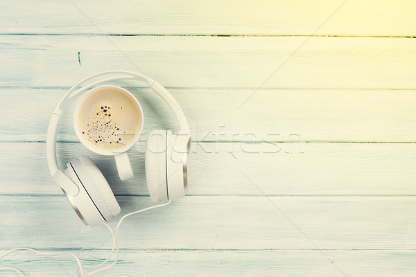Headphones and coffee cup on wooden table Stock photo © karandaev