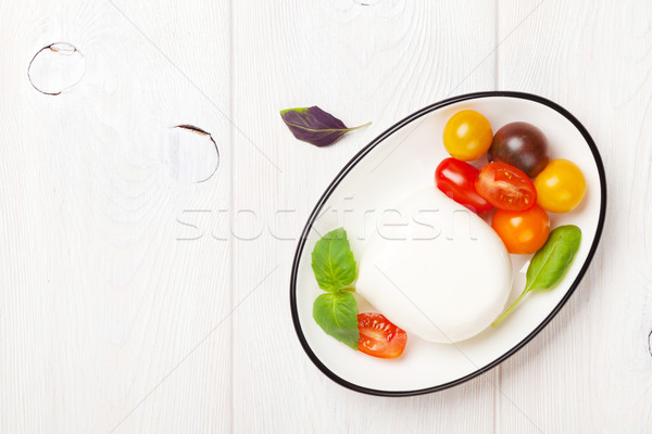 Mozzarella, tomatoes and basil Stock photo © karandaev