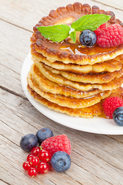 Pancakes with raspberry, blueberry, mint and honey syrup Stock photo © karandaev
