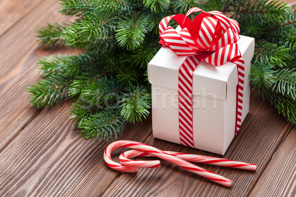 Christmas gift, candy cane and tree branch Stock photo © karandaev