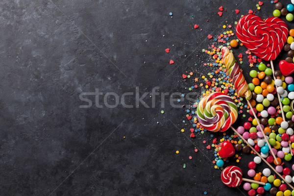 Colorful candies and lollipops over stone Stock photo © karandaev