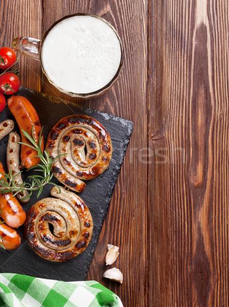 Grilled sausages and beer mug Stock photo © karandaev