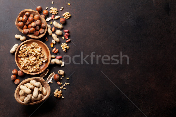 Various nuts on stone table Stock photo © karandaev