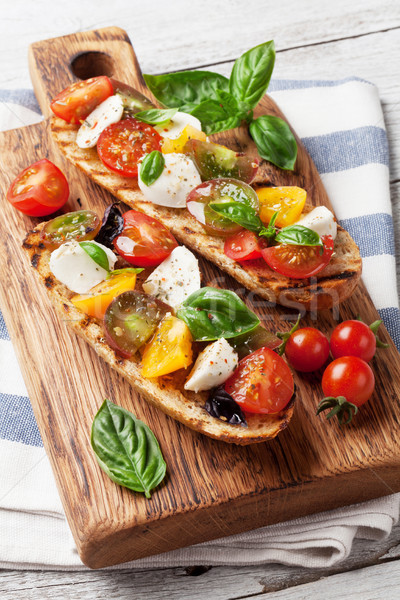 Stock photo: Bruschetta with tomatoes, mozzarella and basil