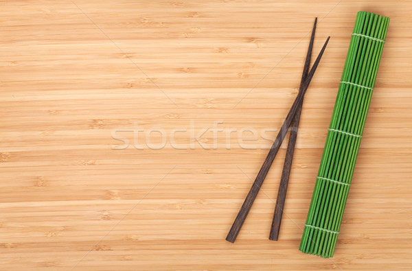 Chopsticks and bamboo mat Stock photo © karandaev