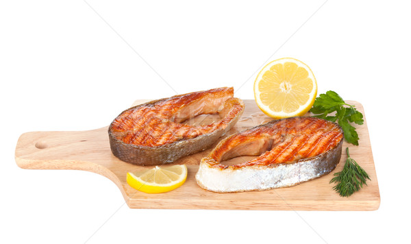 Grillowany łososia cytryny zioła deska do krojenia odizolowany Zdjęcia stock © karandaev
