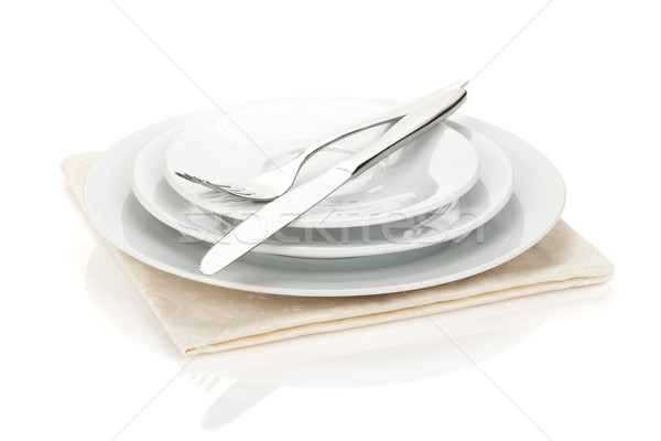 Silverware or flatware set of fork, spoons and knife on plates Stock photo © karandaev
