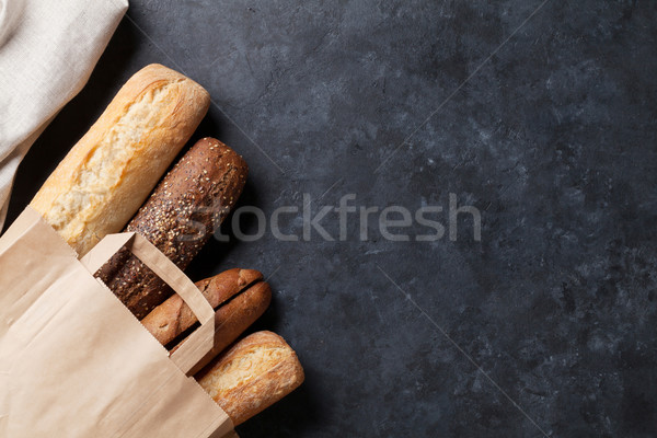 Mixed breads on stone table Stock photo © karandaev