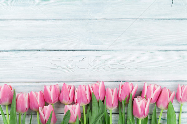 Pink tulips over wooden background Stock photo © karandaev