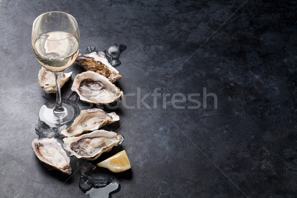 Oysters with lemon and white wine Stock photo © karandaev