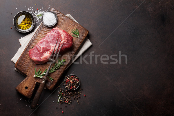 Raw ribeye beef steak cooking with ingredients Stock photo © karandaev