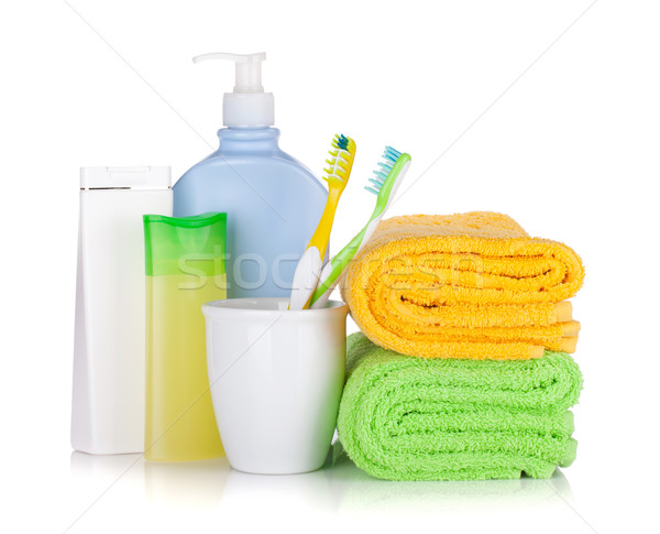Toothbrushes, cosmetics bottles and two towels Stock photo © karandaev