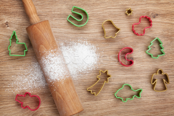 Rolling pin with flour and cookie cutters on wooden table Stock photo © karandaev