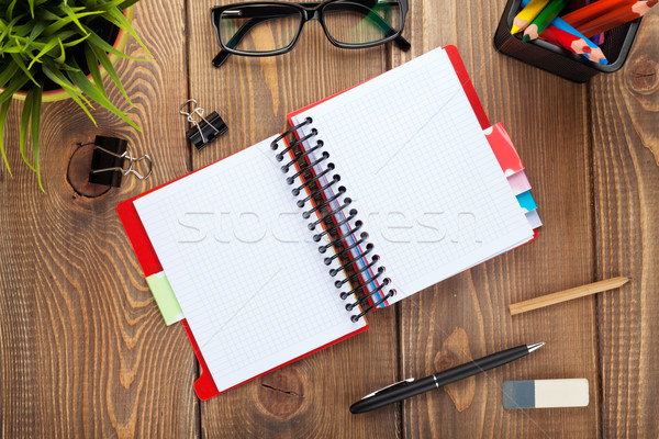 Office table with flower, blank notepad and colorful pencils Stock photo © karandaev