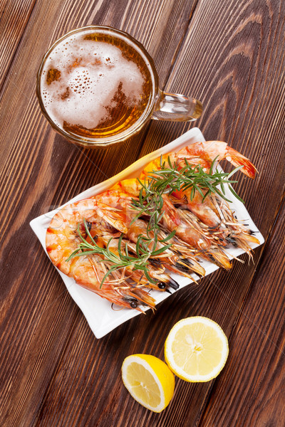Stock photo: Beer mug and grilled shrimps