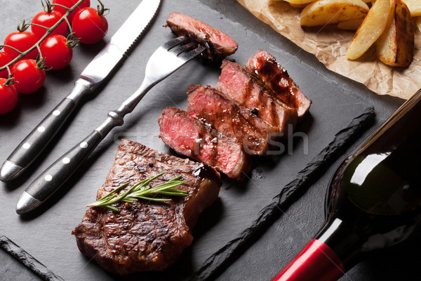 Stock photo: Grilled striploin steak and red wine