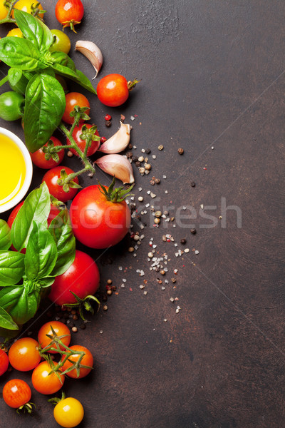 Pomodori basilico olio d'oliva spezie pietra tavola Foto d'archivio © karandaev