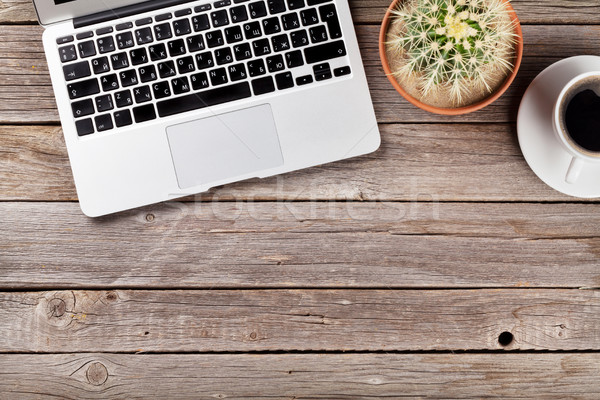 Desk with laptop, coffee and cactus Stock photo © karandaev