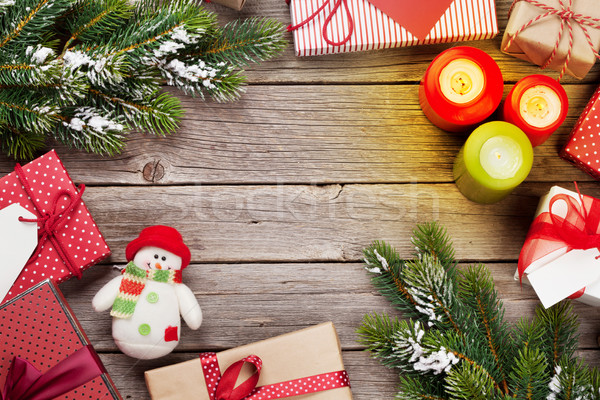 Christmas gift boxes and candles on wooden table Stock photo © karandaev