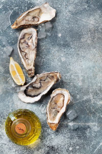 Fresh oysters on stone table Stock photo © karandaev