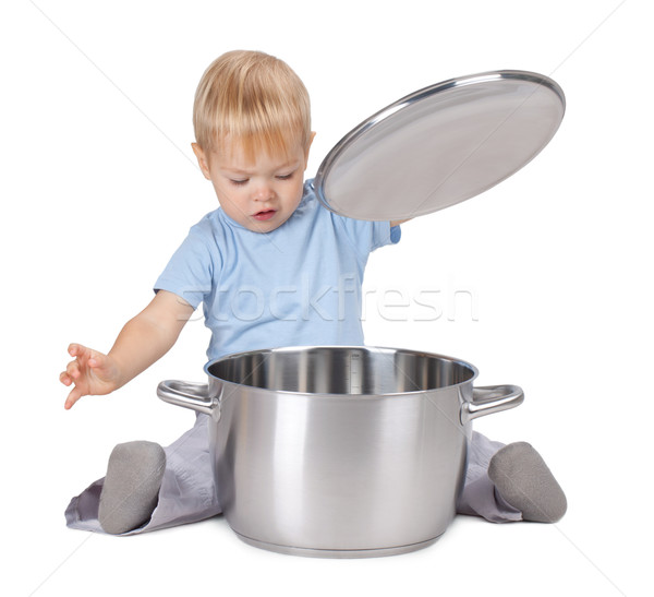 Baby looking inside saucepan Stock photo © karandaev
